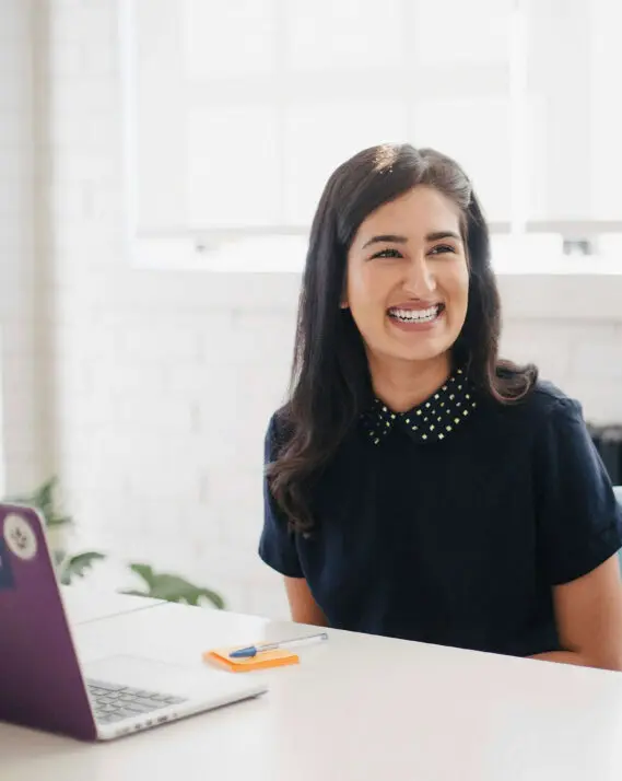 smiling woman at her desk