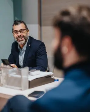 Two colleagues sit together during a professional discussion