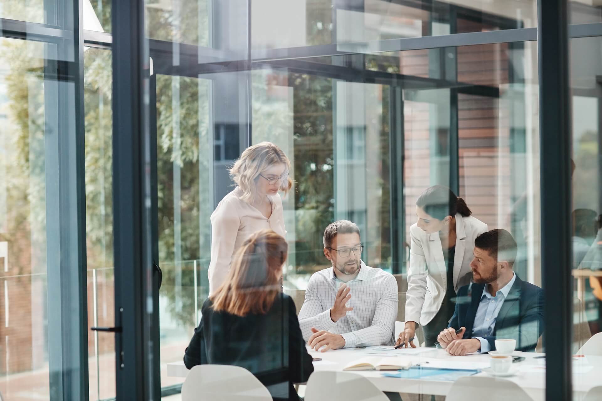 people in a conference room with glass walls
