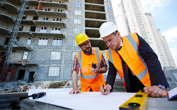 Construction workers discussing building plans