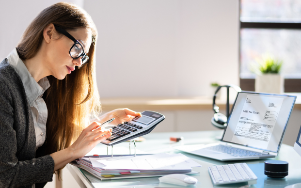 Professional woman calculation taxes at a desk